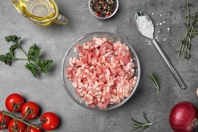 Photo of Flat lay composition with minced meat on grey background