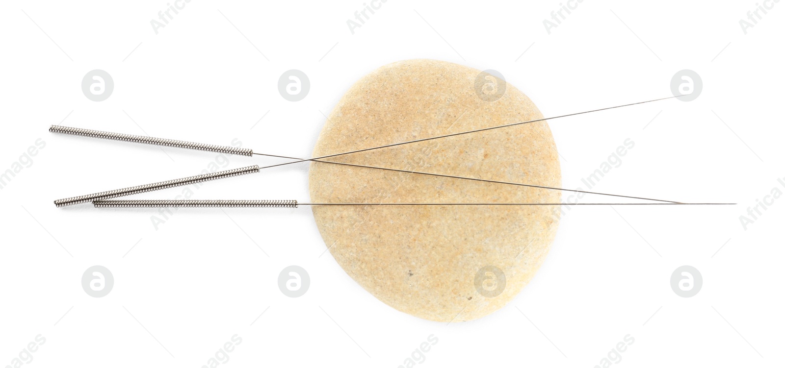 Photo of Many needles for acupuncture and stone on white background, top view