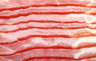 Raw bacon as background, closeup