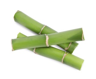 Pieces of beautiful green bamboo stems on white background, top view