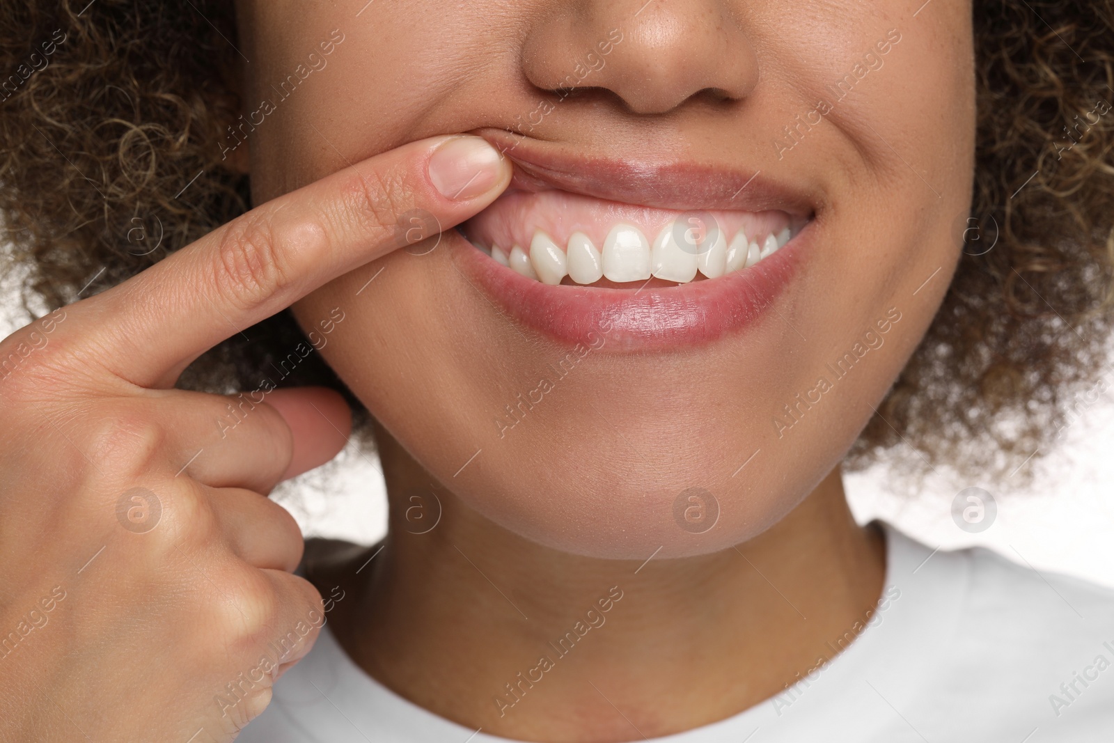 Photo of Woman showing her clean teeth, closeup view