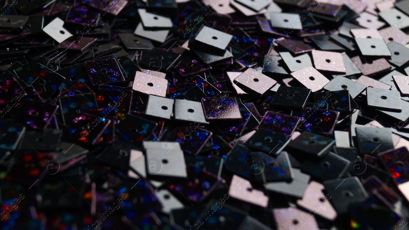 Photo of Many beautiful sequins as background, closeup view