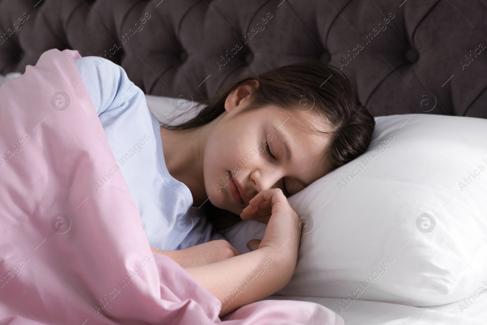 Photo of Beautiful little girl sleeping in bed at home