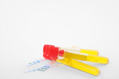 Photo of Test tubes with urine samples for analysis on white background