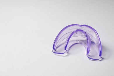 Transparent dental mouth guard on light background, space for text. Bite correction