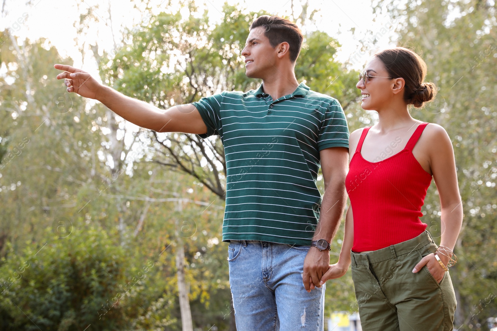 Photo of Lovely couple walking together in park on sunny day