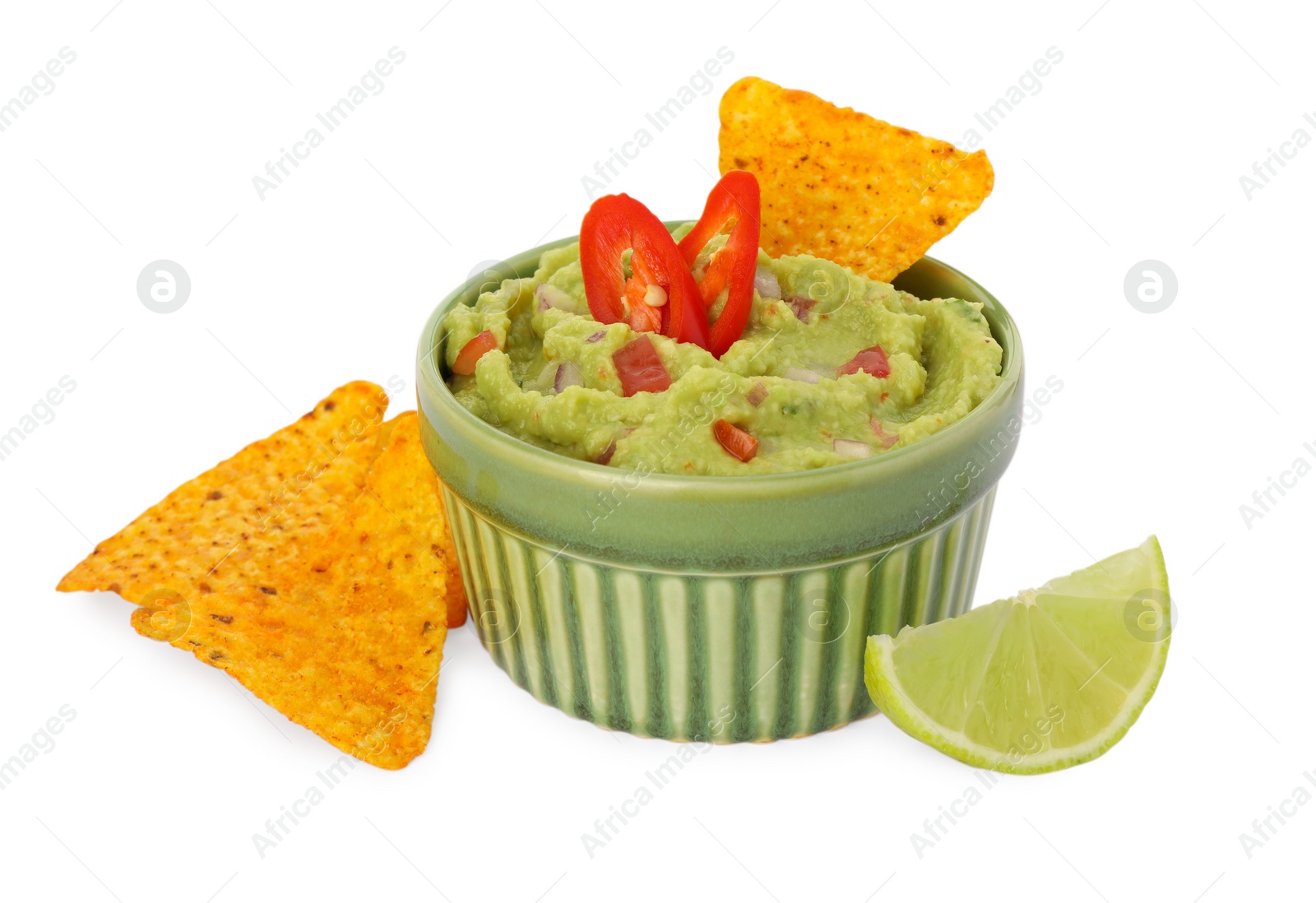 Photo of Bowl of delicious guacamole, lime and nachos chips isolated on white