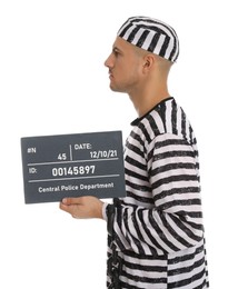 Photo of Mug shot of prisoner in striped uniform with board on white background, side view