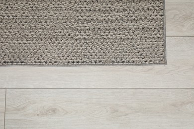 Photo of Soft grey carpet on white laminated floor indoors, top view. Space for text