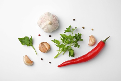 Flat lay composition with green parsley, peppercorns and vegetables on white background