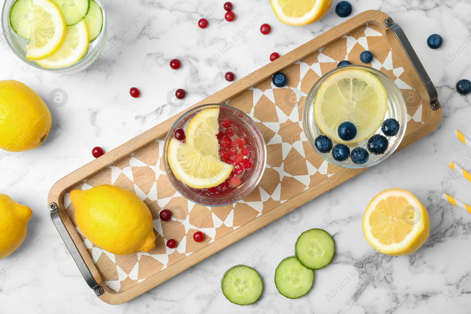 Photo of Flat lay composition with delicious natural lemonade on marble background