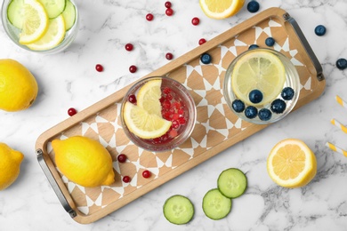 Flat lay composition with delicious natural lemonade on marble background