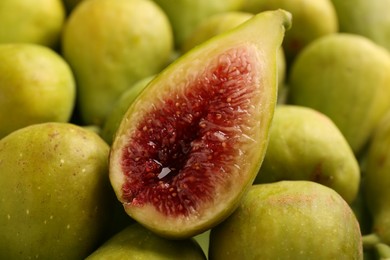 Half of green fig on fresh fruits, closeup