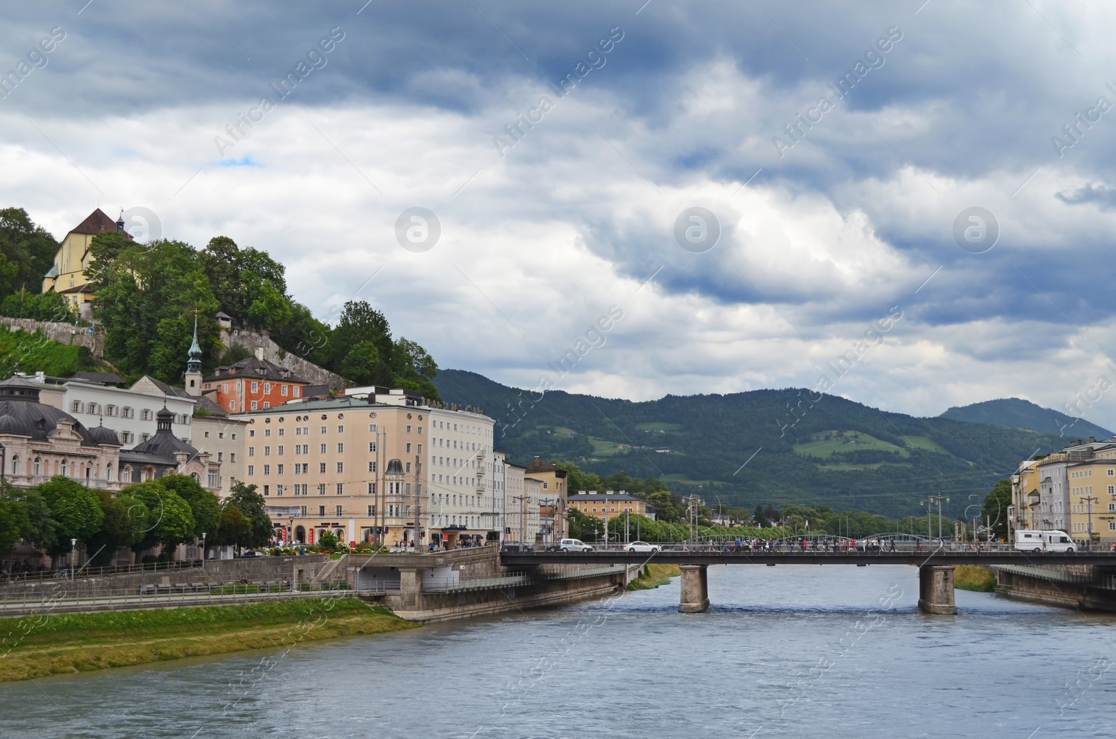 Photo of SALZBURG, AUSTRIA - JUNE 22, 2018: Picturesque view of city street and bridge over river