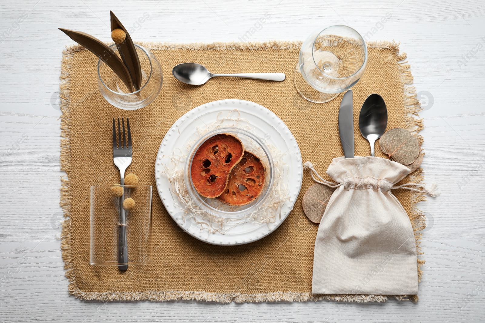 Photo of Autumn table setting with dried pumpkin slices on white wooden background, flat lay