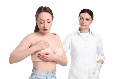 Woman doing breast self-examination during mammologist's appointment on white background