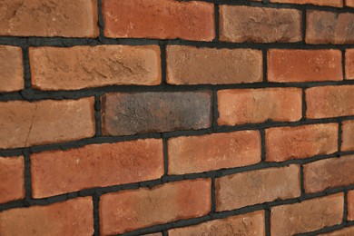 Photo of Decorative bricks on wall as background, closeup. Tiles installation process