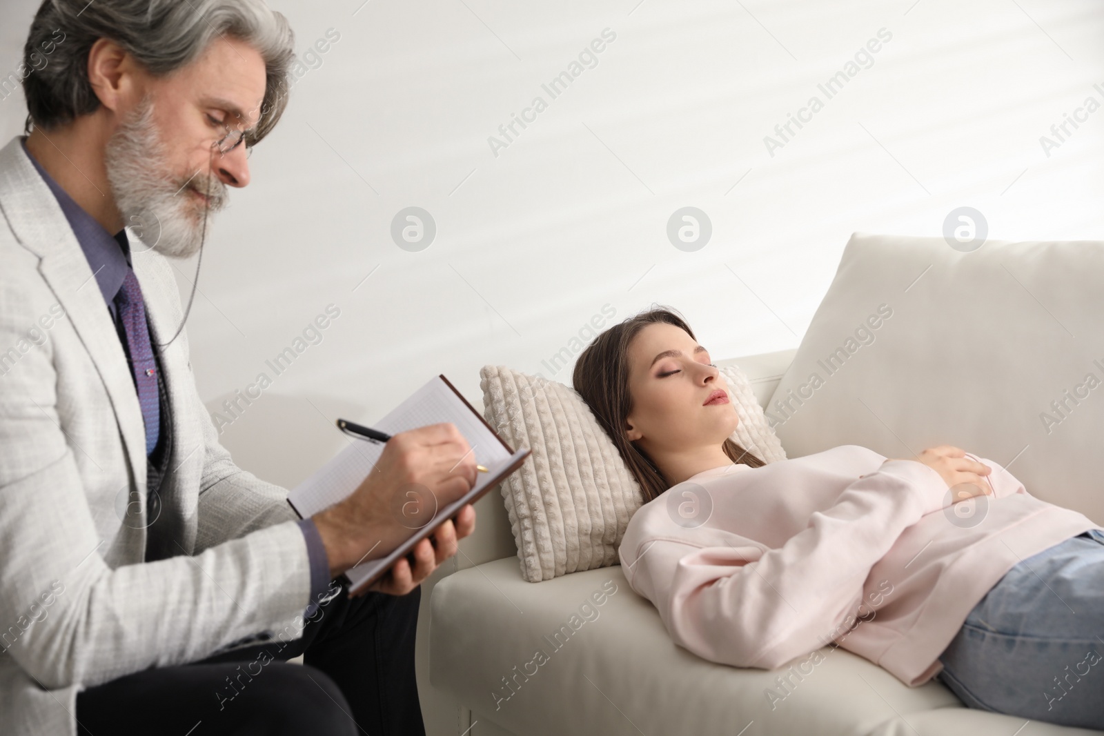 Photo of Psychotherapist and patient in office. Hypnotherapy session