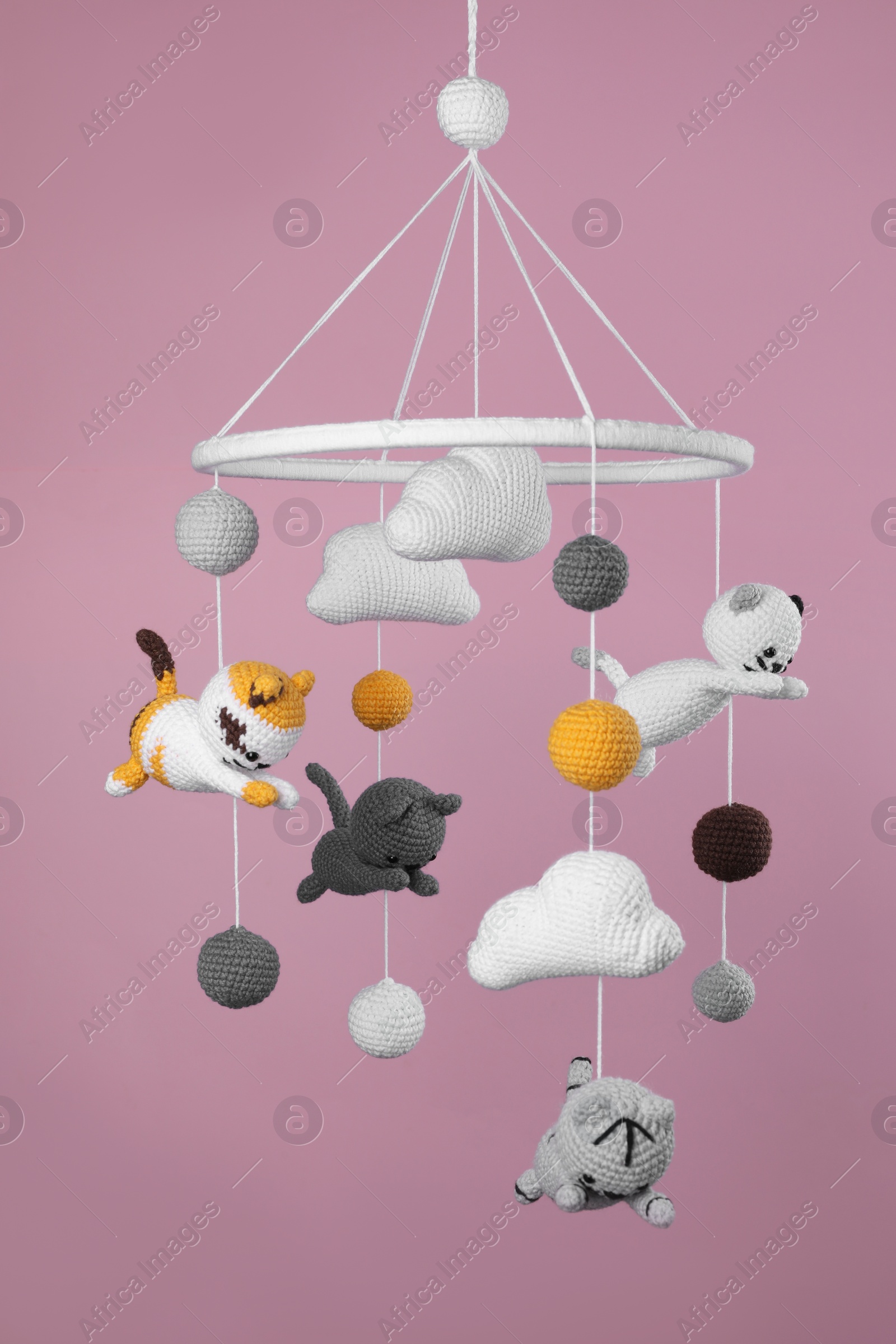 Photo of Cute baby crib mobile on pink background