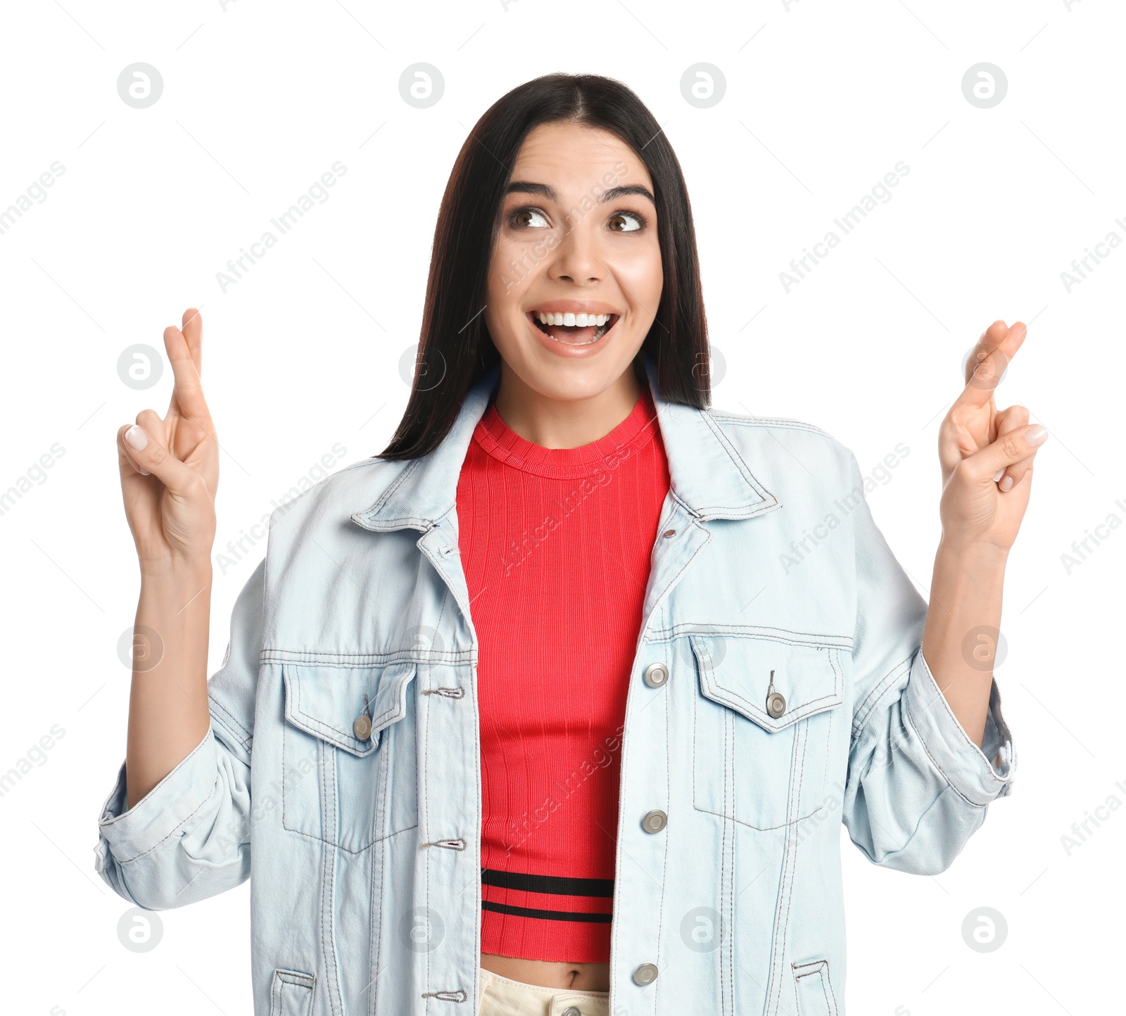 Photo of Woman with crossed fingers on white background. Superstition concept