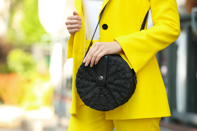 Photo of Young woman with stylish handbag outdoors on summer day, closeup