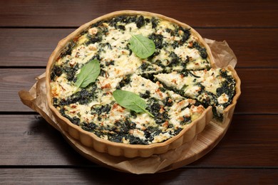 Delicious homemade spinach quiche on wooden table
