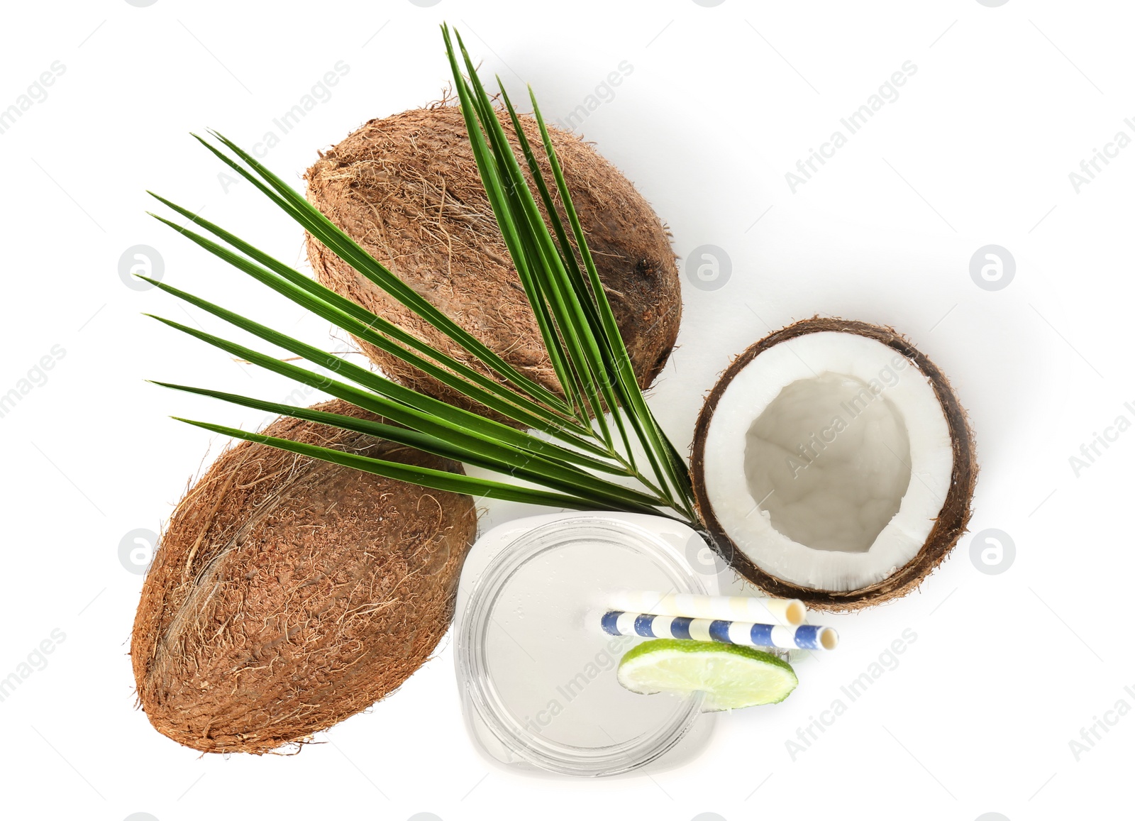 Photo of Mason jar with coconut water and nuts on white background, top view