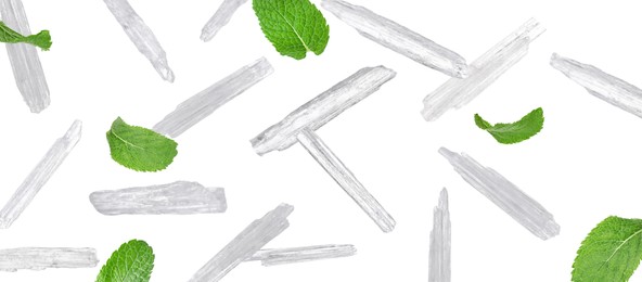 Image of Translucent menthol crystals and green mint leaves falling on white background. Banner design