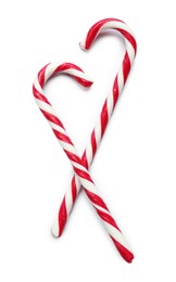 Sweet candy canes on white background, top view. Christmas treat 