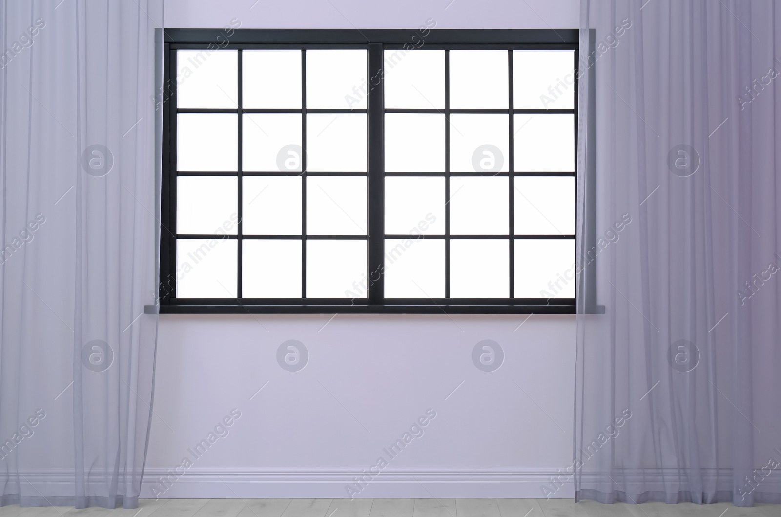 Photo of Empty room with window and open curtains. Home interior