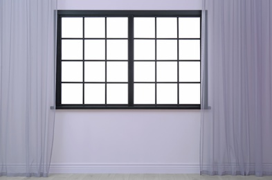 Photo of Empty room with window and open curtains. Home interior