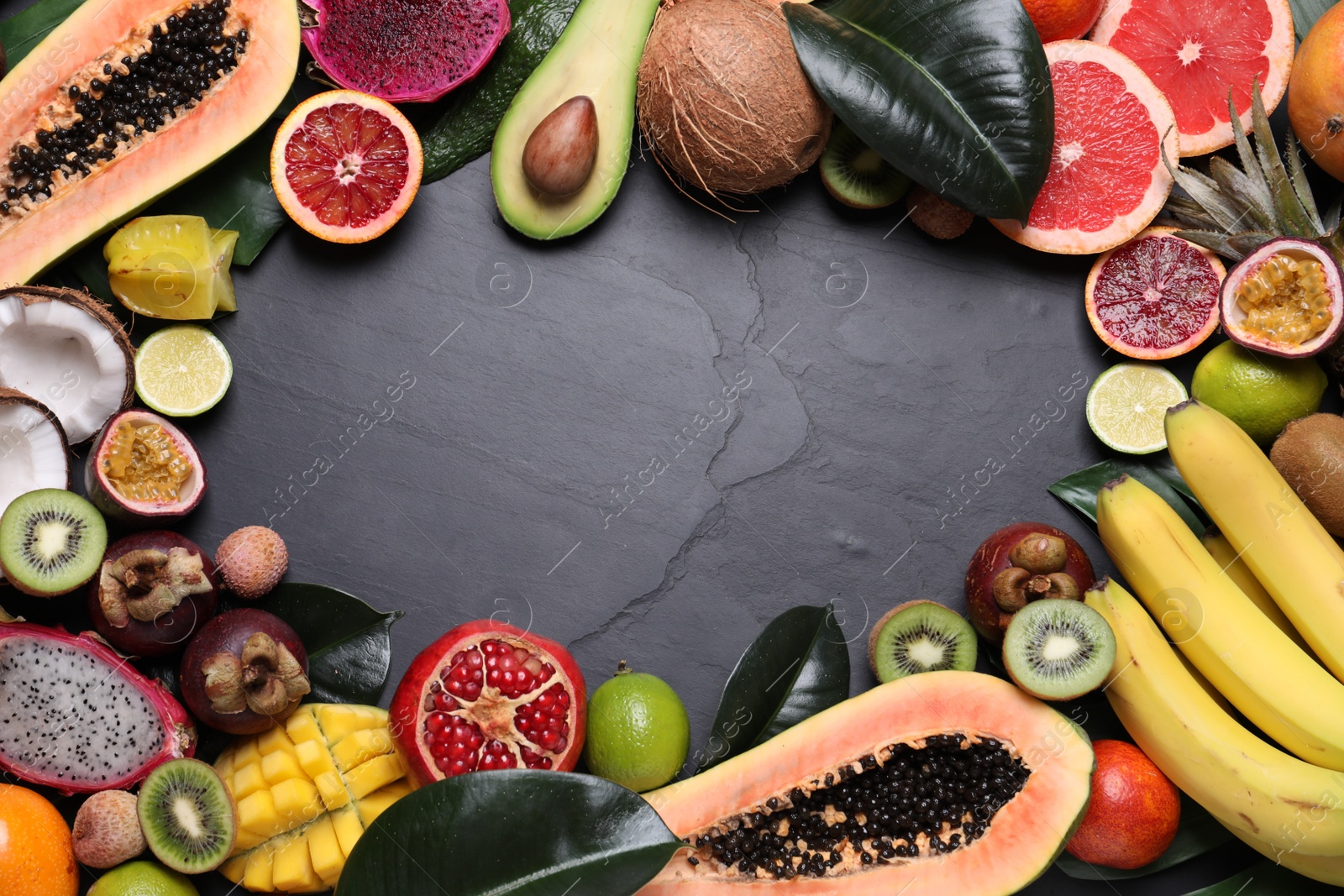 Photo of Frame of different exotic fruits on black background, flat lay. Space for text