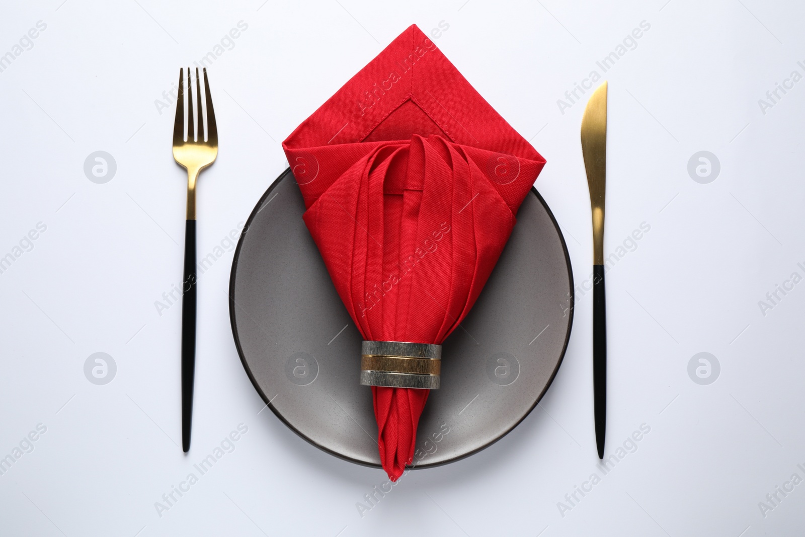 Photo of Beautiful table setting with red napkin on white background, top view