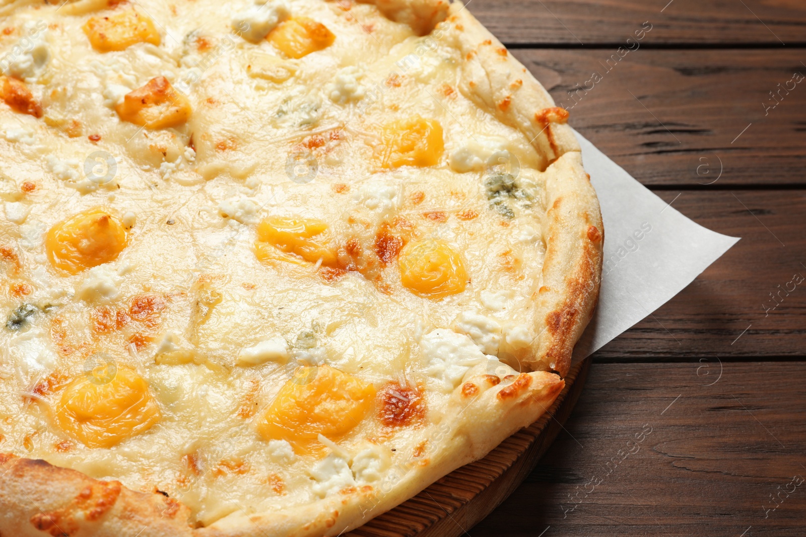 Photo of Hot cheese pizza Margherita on wooden table, closeup