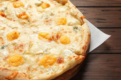 Photo of Hot cheese pizza Margherita on wooden table, closeup