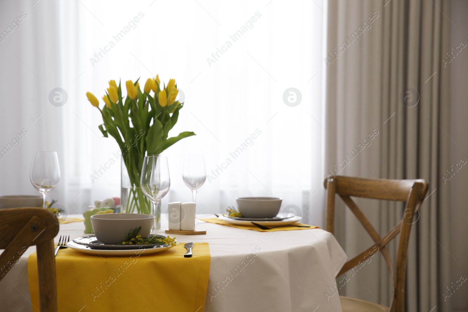 Photo of Beautiful Easter table setting with floral decor indoors