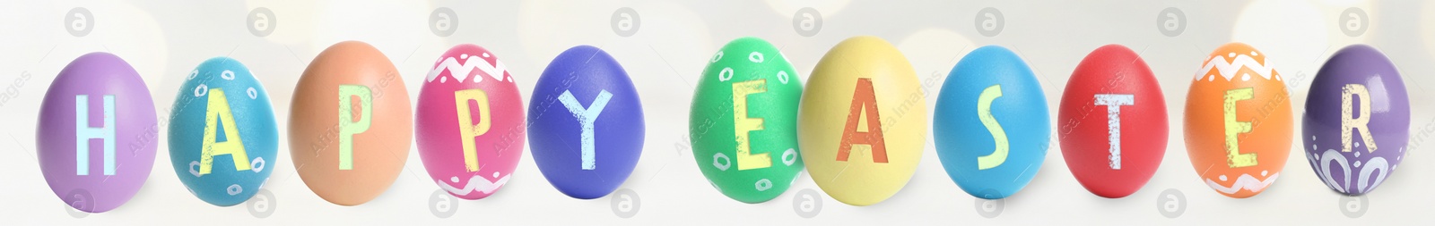 Image of Happy Easter. Colorful dyed eggs on light background, banner design