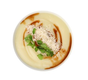 Photo of Delicious cream soup with parmesan cheese, soy sauce and parsley in bowl isolated on white, top view