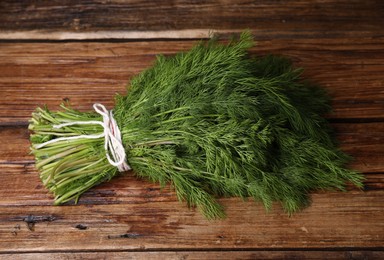 Bunch of fresh green dill on wooden table