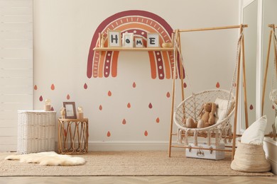 Photo of Child's room interior with rainbow painting on wall