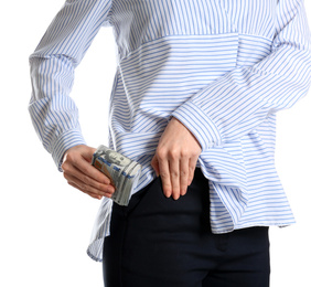 Photo of Woman putting bribe into pocket on white background, closeup