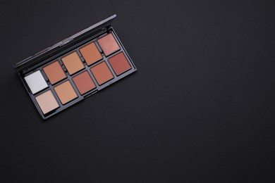 Photo of Contouring palette on black background, top view with space for text. Professional cosmetic product