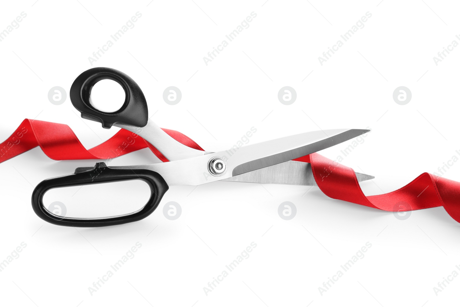 Photo of Stylish scissors and red ribbon on white background. Ceremonial tape cutting