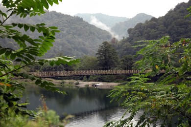 Beautiful view on rusty metal bridge over river in mountains