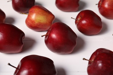 Photo of Fresh red apples on white wooden table, closeup