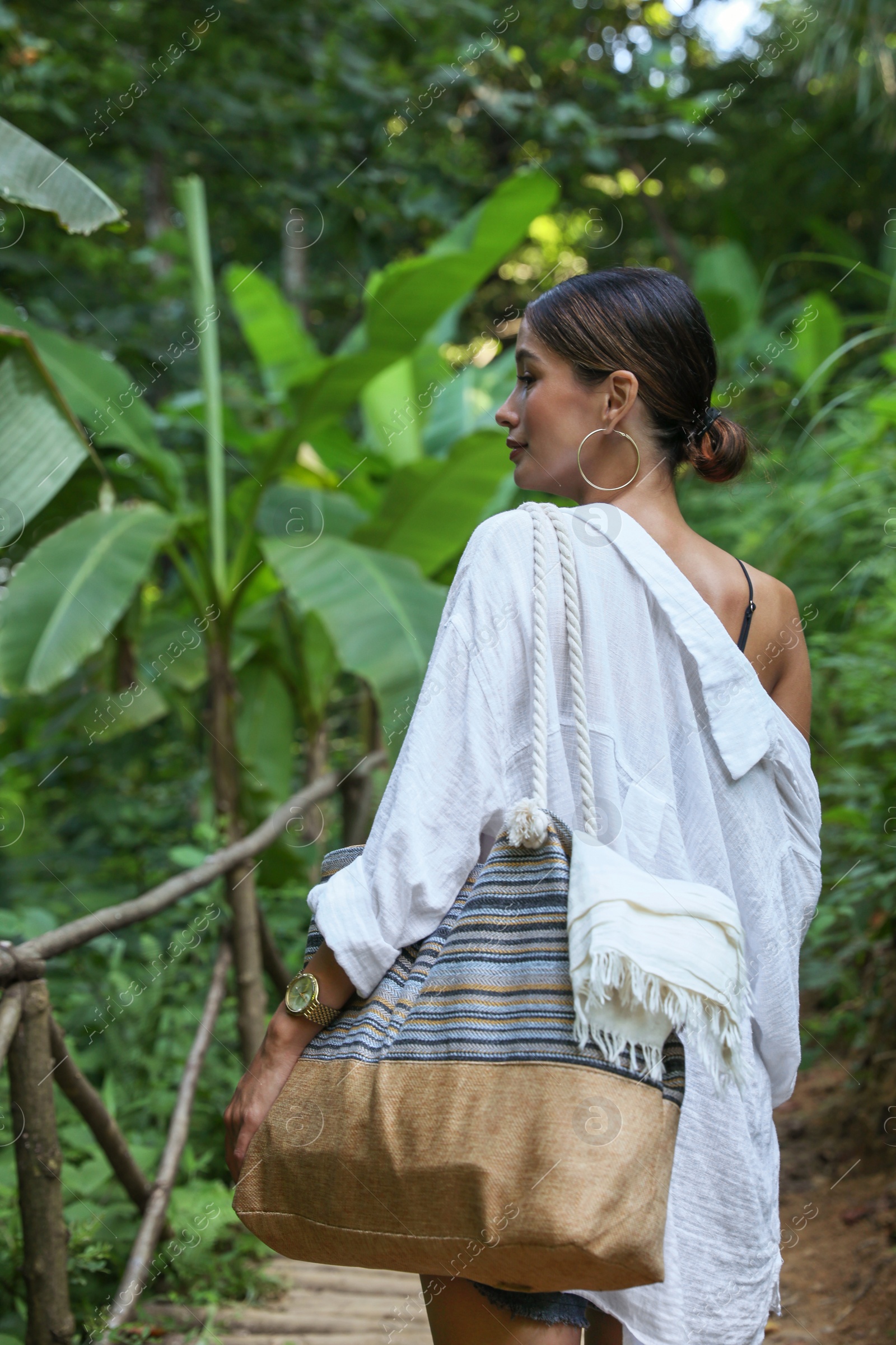 Photo of Beautiful young woman in green tropical park