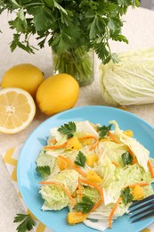 Tasty salad with Chinese cabbage and products on table