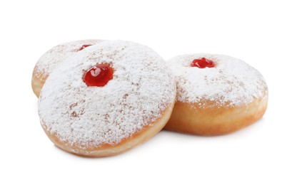 Delicious donuts with jelly and powdered sugar on white background