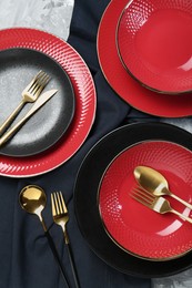 Photo of Stylish ceramic plates and cutlery on table, flat lay