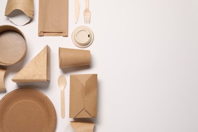 Photo of Eco friendly food packaging. Paper containers, bag and tableware on white background, flat lay. Space for text